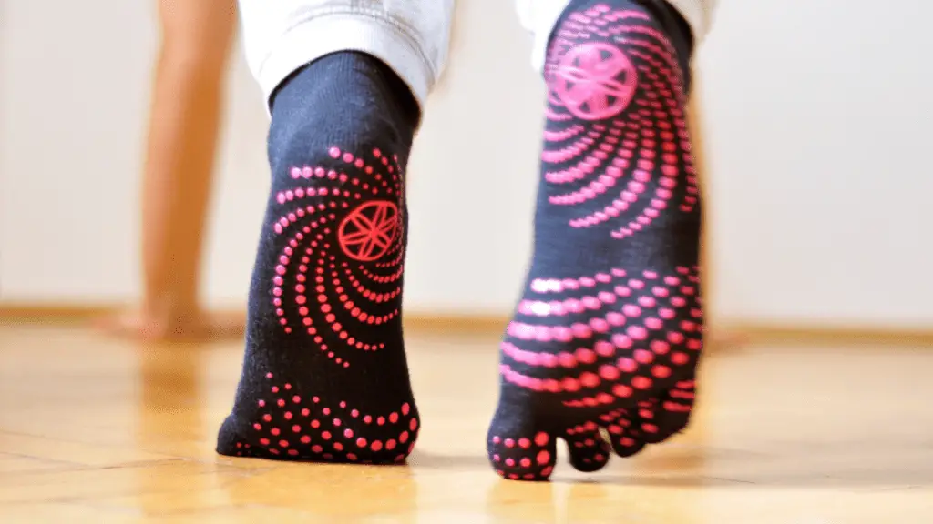 Person practicing yoga whilst wearing yoga socks
